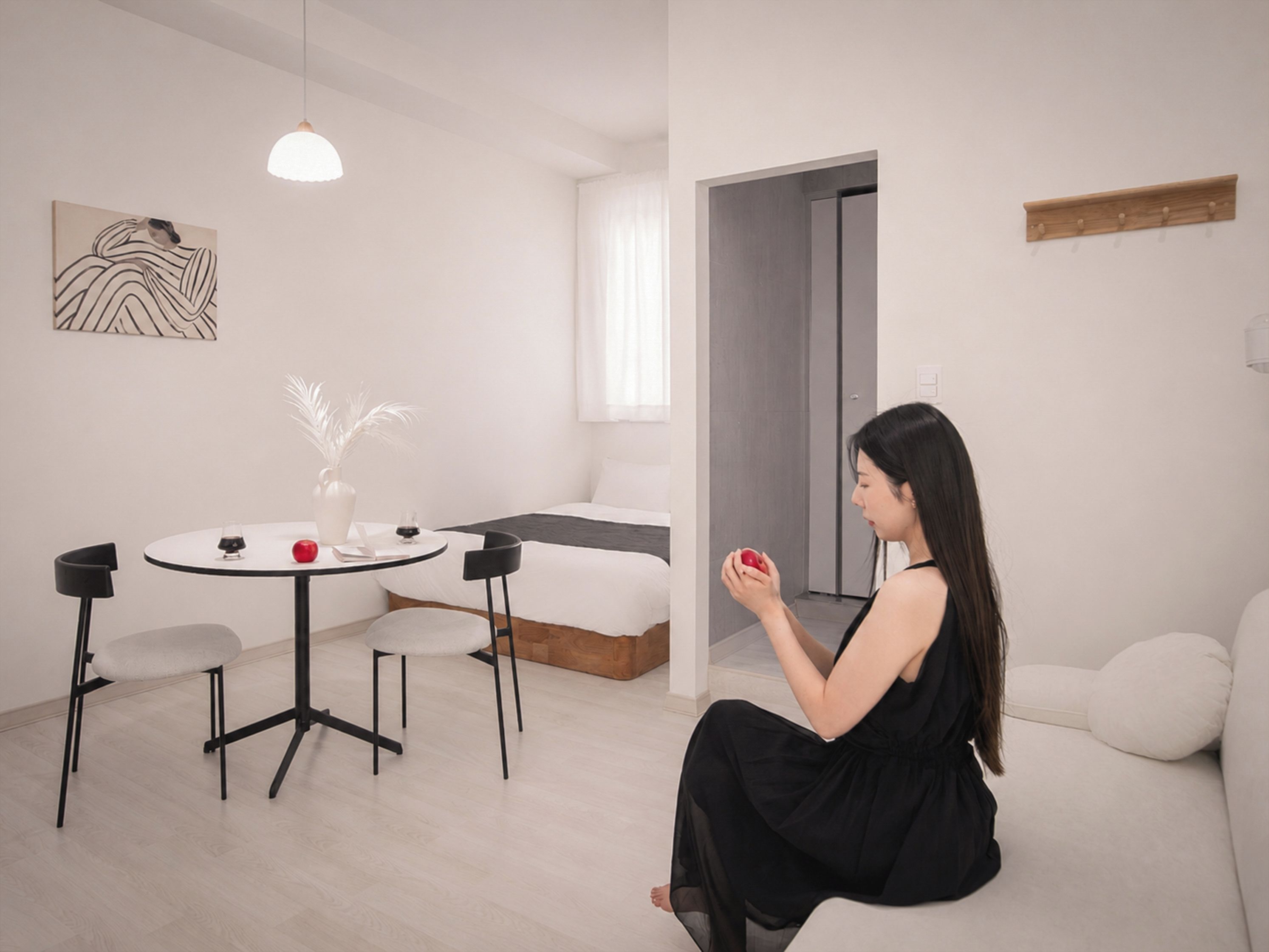 A modern living room with a sofa, a dining table with chairs, and a minimalist decor.