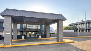 A gas station with a canopy, a car wash, and a building with multiple windows in the background. - Studio King Unit | Close to Hutchinson County Museum - 0.9 miles (Borger)