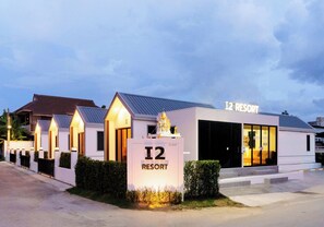 A resort building with a sign indicating 'I2 RESORT' and a large entrance.