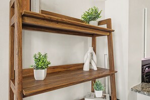 A wooden shelf with two potted plants and a white vase. - New Cozy 3BR Apt - Perfect for Families & Groups (Indianapolis)