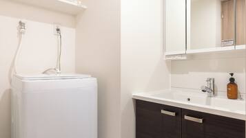 Separate bathtub and shower, hair dryer, towels, soap