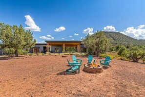 A modern building with a covered patio area, outdoor seating, and a fire pit. - Rojo Retreat - Main 2BR Unit, Hot Tub, Patio (Sedona)