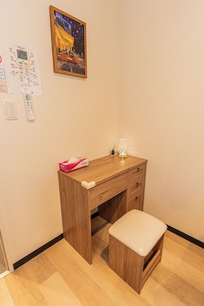 A wooden desk with a drawer, a small stool, a tissue box, and a wall-mounted light fixture. - Kiyoka Ryokan Shinkoiwa No.2 (Katsushika-ku)