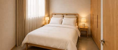 A bedroom with a bed, bedside lamps, a wooden wardrobe, and a window with curtains.