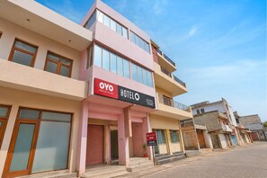 A hotel with a modern facade, multiple balconies, and a clear sky. - Deluxe Mehar Sunflower (Kharar)