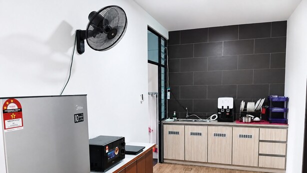 A modern kitchen with a built-in dishwasher, a coffee machine, and a microwave.