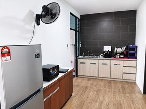 A modern kitchen with a built-in dishwasher, a coffee machine, and a microwave.