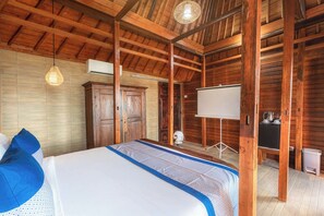 A wooden room with a bed, a wardrobe, a whiteboard, and a desk with a kettle. - Miyasabiasa Hills Nusa Penida (Penida Island)