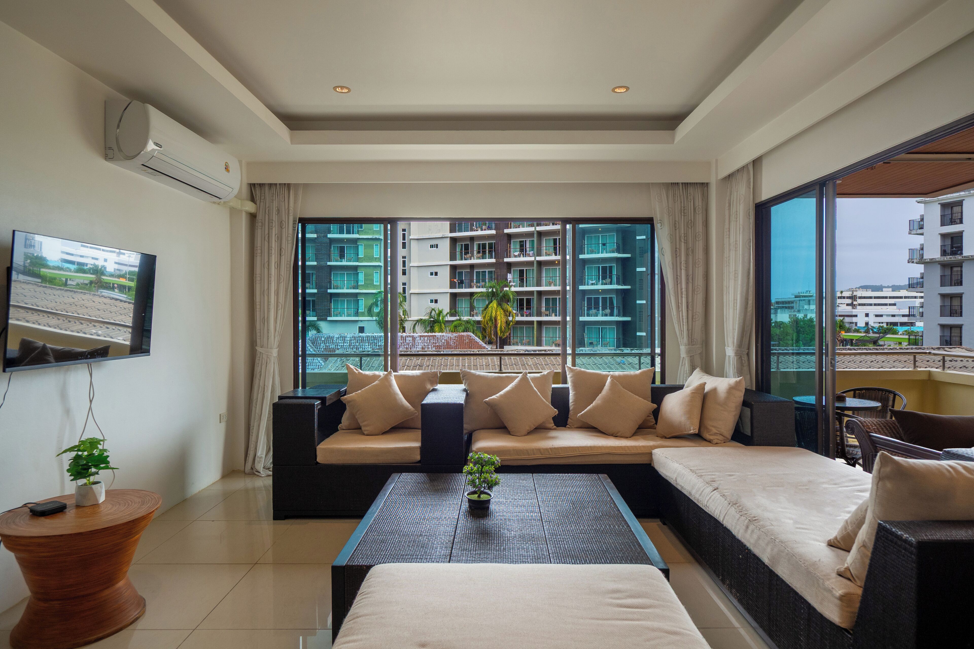A modern living room with a sofa set, a coffee table, and a television.