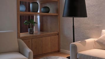 A modern living room with a sofa, a lamp, a wooden shelving unit with decorative items, and a fluffy rug.