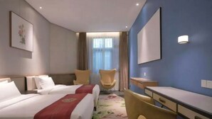 A hotel room with two beds, a desk, a chair, and a large window with curtains. - Nanxianglou Art Hotel (Shenzhen)