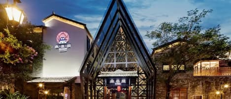 A traditional building with a prominent triangular roof structure and a sign with Chinese characters.