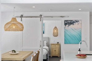 A modern interior with a dining area, a kitchen, and a bathroom. - The Riverside Wander, Noosaville (Noosaville)
