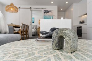 A modern interior with a round table, a sofa, and a dining area. - The Riverside Wander, Noosaville (Noosaville)