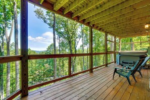 A wooden deck with a view of a forest, a grill, and outdoor seating. - Mtn Views, Hot Tub, & Theater! Sevierville Gem (Sevierville)