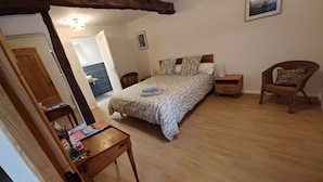 A bedroom with a wooden bed, a wooden nightstand, a chair, a wooden desk, and a mirror. - Pechingorp Guest Room - Tilleul - Shared Pool, Terrace, and Wi-Fi (Le Verdier)