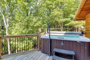 A hot tub on a wooden deck with a wooden railing, surrounded by trees. - Dahlonega Wine Country Cabin w/ Hot Tub! (Dahlonega)