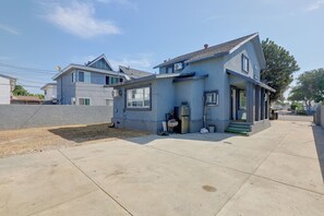 A residential property with a two-story house, a garage, and a paved driveway. - Walkable Location! Spacious Huntington Park Home (Huntington Park)