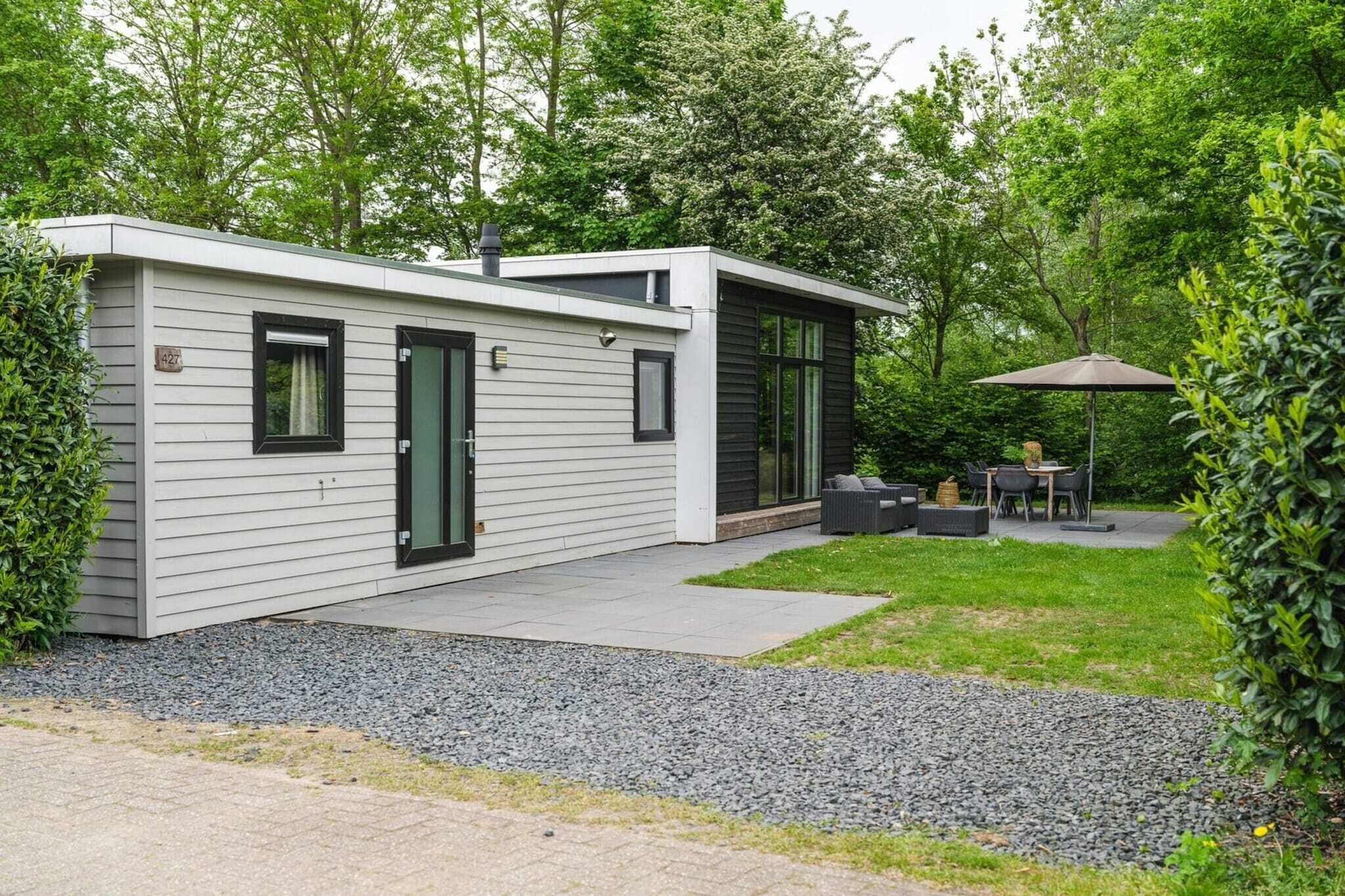 A modern two-story house with a covered patio area.
