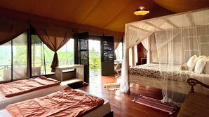 A room with a bed, two bedside tables, a window with curtains, and a ceiling light.