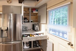 A kitchen with a stainless steel refrigerator, built-in oven, and a window with blinds. - 'StrautmanHaus' All-Season Berkshire East Chalet (Charlemont)