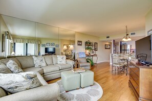 A spacious living room with a large sectional sofa, a dining area with a wooden table and chairs, and a kitchen with modern appliances. - Steps to Sand! Extended Bradenton Beach Getaway (Bradenton Beach)