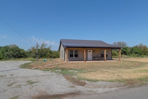 A small, single-story building with a flat roof and a porch. - Gateway to State Park & Lake! Inviting Vian Cabin (Vian)
