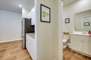 A modern kitchen with a refrigerator, cabinets, and a countertop. - Hammock, Grill & Patio! Sunfish Cove Home (Sunset Beach)