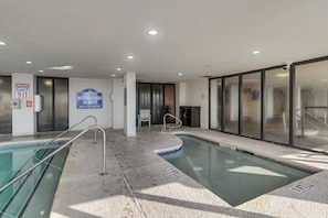 An indoor swimming pool with clear signage, including a 'No Lifeguard on Duty' sign, and a 'Swim at Your Own Risk' notice. - 14th-Floor Ocean View + Pools! Myrtle Beach Haven (Myrtle Beach)