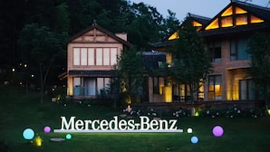 A two-story building with a traditional architectural style, featuring a prominent entrance and a well-maintained lawn.
