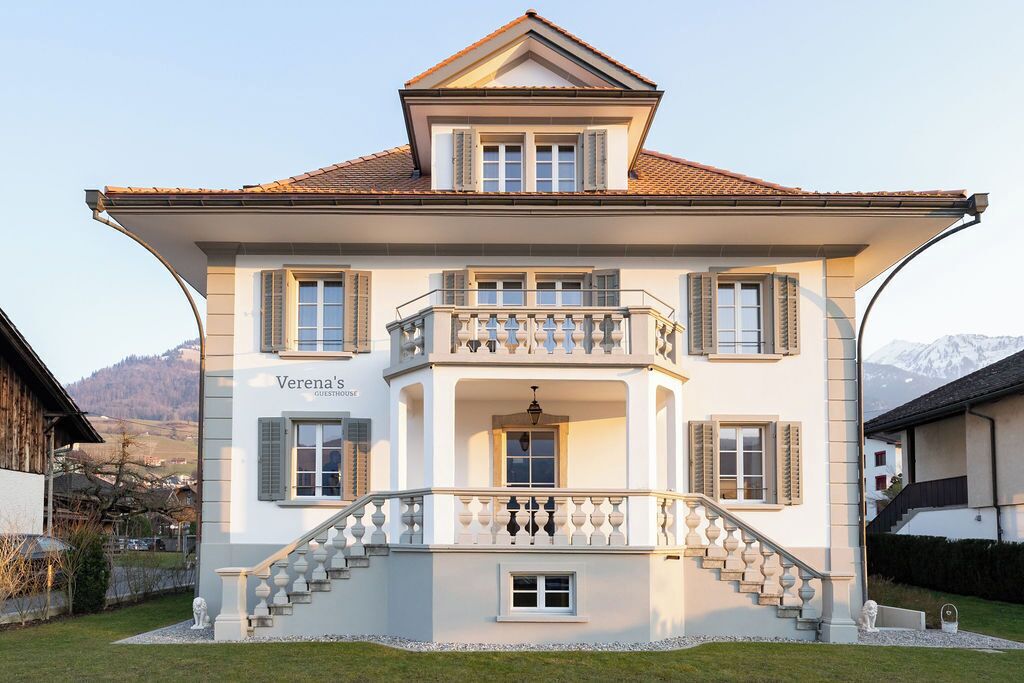 A two-story building with a balcony, a staircase, and a sign that reads 'Verena's.'