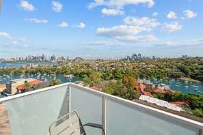A balcony with a view of a city skyline, marina, and residential area. - Penthouse Near Taronga Zoo w/ Iconic Harbour Views (Mosman)