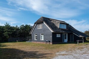 A single-story house with a gabled roof, a front door, and a small porch area. - Holiday apartment in Buren with swimming pool (Buren)