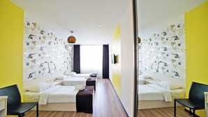 A hotel room with two beds, a desk, and a chair. - Plaza Inn Batumi (Batumi)