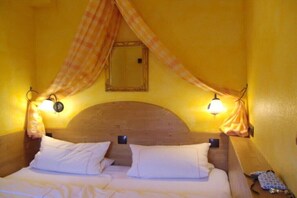 A room with a bed, two wall-mounted lamps, and a canopy. - Holiday apartment with 1 bedroom (Freinsheim)
