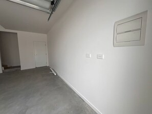 A room with a plain white wall, a door, and a vent on the wall. - Your Buddina Escape:Swim, Sip & Unwind by the Pool (Buddina)