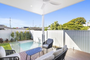 A covered outdoor area with a pool, seating, and a view of the neighborhood. - Your Buddina Escape:Swim, Sip & Unwind by the Pool (Buddina)