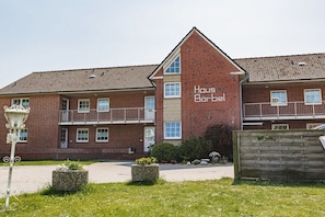 A two-story brick building with a sign reading 'Haus Barbel.' - House Bärbel Apartment No. 3 (Cuxhaven)