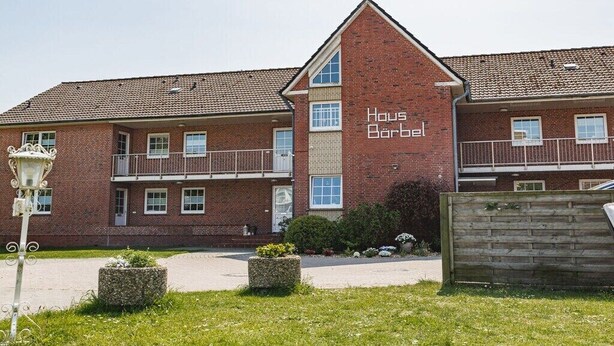 A two-story brick building with a sign reading 'Haus Barbel.' - House Bärbel Apartment No. 4 (Cuxhaven)