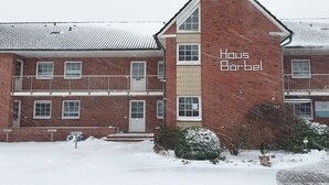 A two-story brick building with the name 'Haus Börbel' on the facade. - House Bärbel Apartment No. 4 (Cuxhaven)