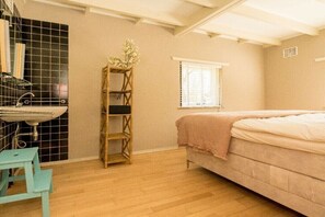 A bedroom with a bed, a window, a sink, and a shelf. - Holiday home in Renesse with swimming pool (Renesse)