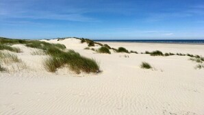 A sandy beach with dunes and a clear sky. - Holiday apartment in Juist with swimming pool (Juist)