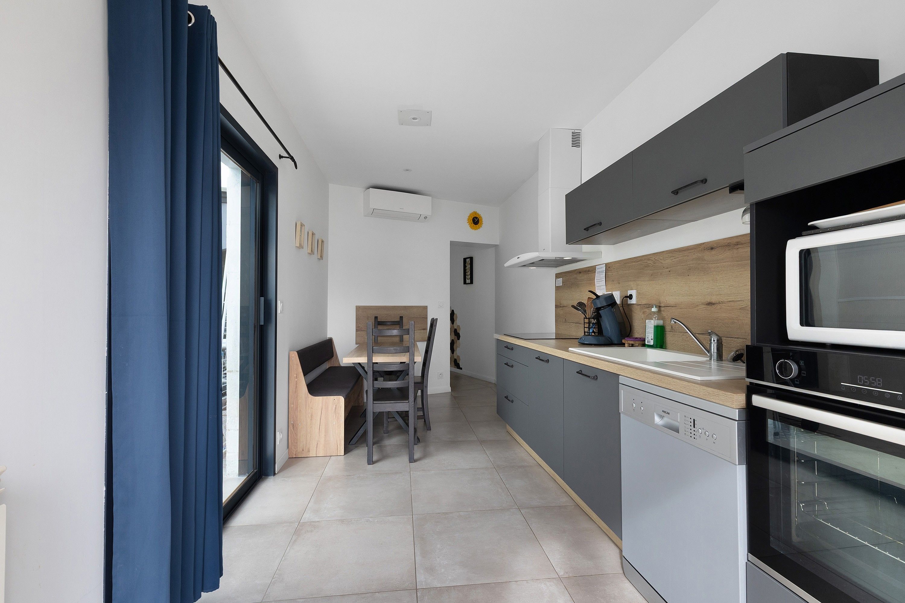 A modern kitchen with a built-in oven, microwave, and dishwasher.