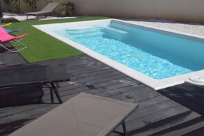 A rectangular swimming pool with a wooden deck and a small hot tub. - Holiday home in Vias with swimming pool (Vias)