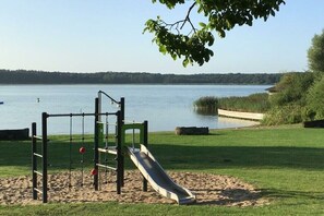 A playground with a slide and climbing structures near a lake. - I have a house by the lake, apartment 3 (Hohen Viecheln)