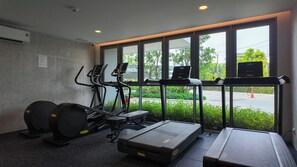 A gym with treadmills, elliptical machines, and weight benches. - 2BR family suite near Boat Lagoon (BangTao)