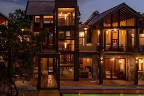 A multi-story building with a pool in the foreground.