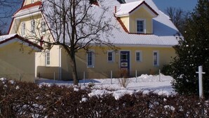 A two-story house with a snow-covered roof and a visible chimney. - Vrbo Property (Ostseebad Prerow)