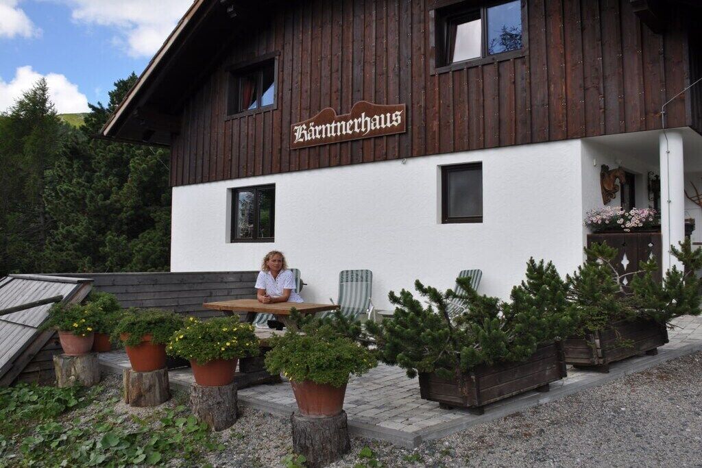 A building with a sign reading 'Bärntnerhaus' and a person sitting at an outdoor table.