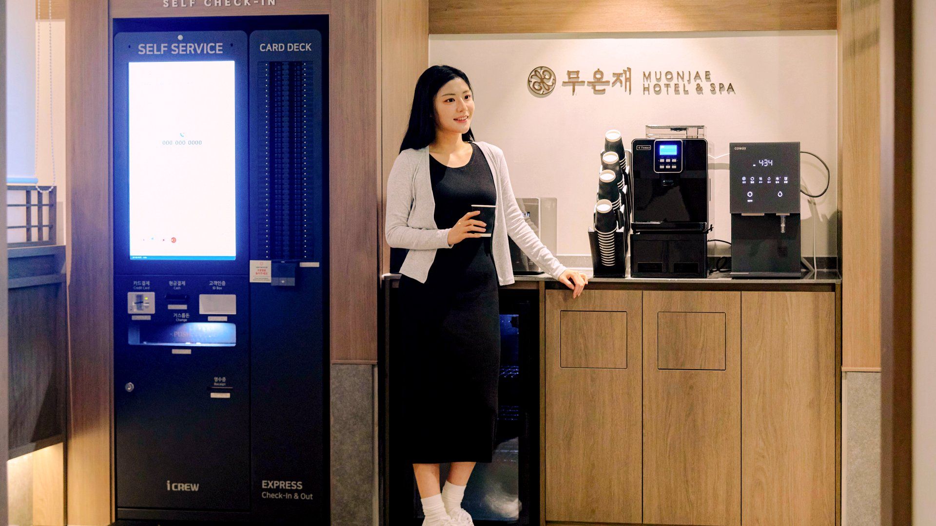 A self-service check-in kiosk with card deck and coffee machines.